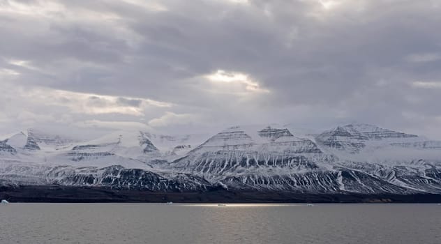Sun Breaking Through the Ocean Clouds along a Remote Coast of Greenland along the Nugssuaq Peninsula