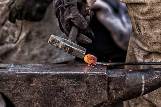 Detail shot of metal being worked at a blacksmith forge