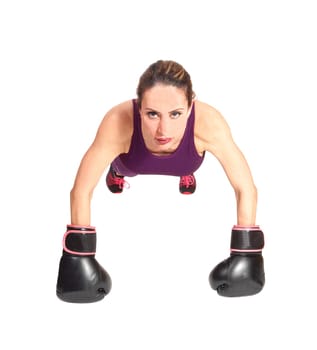 A pretty brunette woman with black boxing gloves doing some punch-ups.in the floor, isolated for white background.