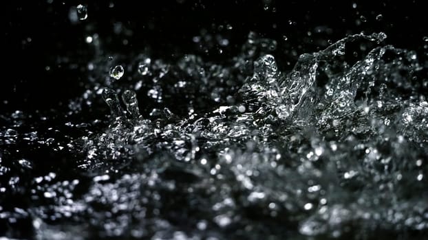 Water splash on black background color which represent clean and pure natural freshness of liquid for healthy drink or sparkling water