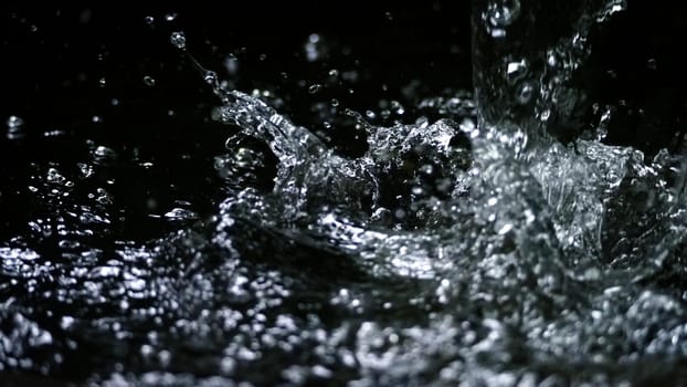 Water splash on black background color which represent clean and pure natural freshness of liquid for healthy drink or sparkling water