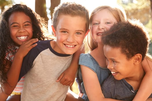 Portrait Of Children With Friends On Hiking Adventure In Woods
