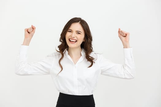Business Concept: young happy businesswoman with hands in the air is celebrating success on white background.