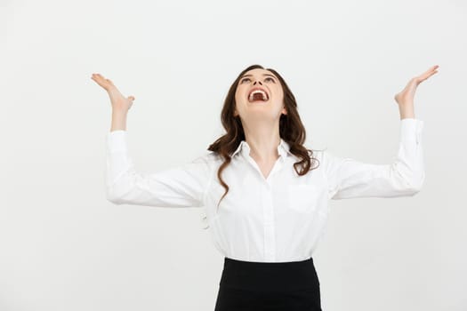Business Concept: young happy businesswoman with hands in the air is celebrating success on white background.