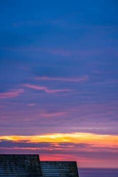Wooden children playground hut roofs and the beautiful sky at sunset over the Cornish coast, St. Ives, Cornwall, England