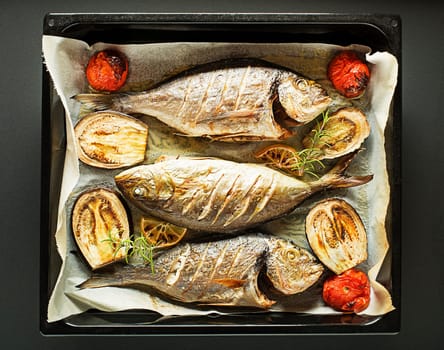 Grilled Gilt-head bream fish with vegetables and spices