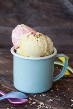 Colorful ice cream balls in enamel cup with sugar sprinkles