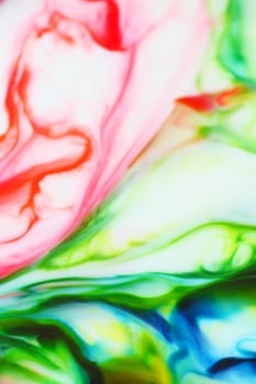 Paints in red, green, yellow and blue on a white background