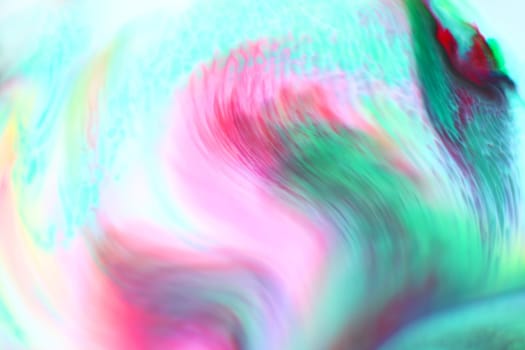 Red, green and blue paint blend into a wave-like form