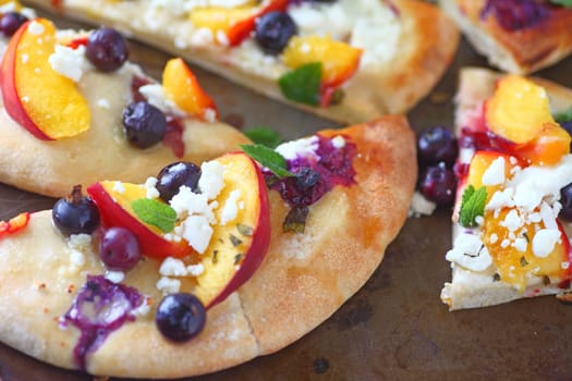 Blueberries and peaches with feta cheese on naan bread