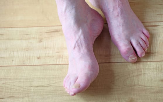 Two male feet on the floor