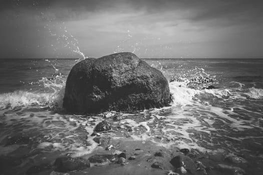 Boulder in the surf - Baltic Sea beach Schleswig-Holstein - in a close-up - black and white