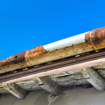 Broken gutter on the roof of a house