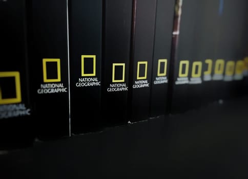 Rome, italy, June 29th 2018: spines of Black books stored in a shelf with the National Geographic logo