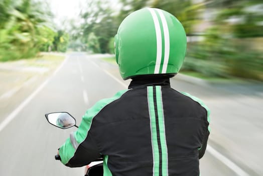 Rear view of motorcycle taxi on the way in the city