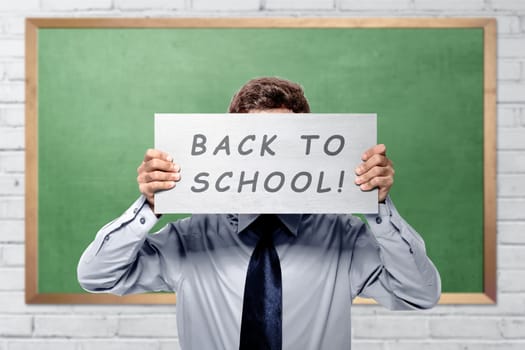 Young college student with back to school message against chalkboard background