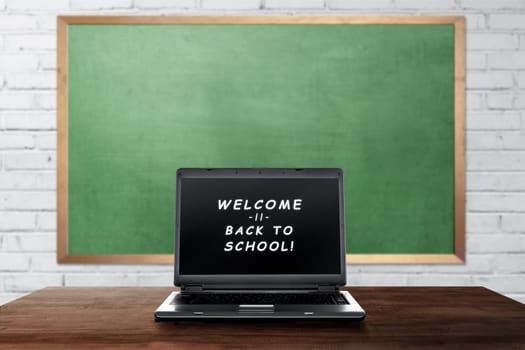 Welcome back to school text on laptop screen on the classroom