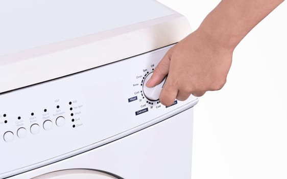Close up of hand adjusting washing machine program isolated over white background