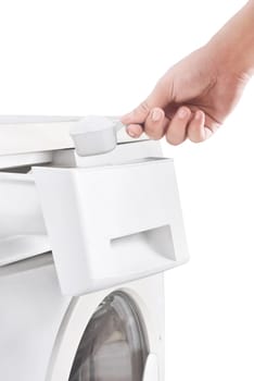 Human hands put the detergent into the washing machine isolated over white background