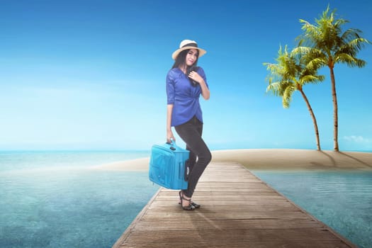 Pretty asian tourist woman with suitcase having fun on summer vacation