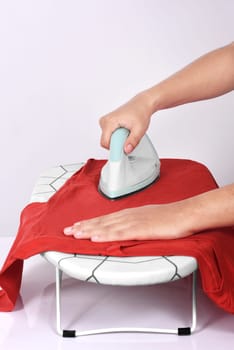 People ironing colored clothes on ironing board isolated over white background