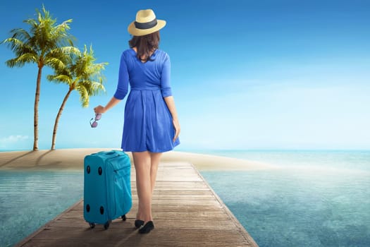 Rear view of asian woman with hat and sunglasses walking on wooden pier