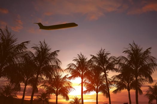 Plane flying above tropical island at sunset