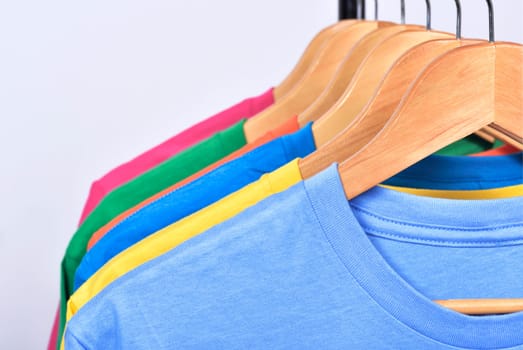 Colorful clothes hang on a shelf after washing isolated over white background