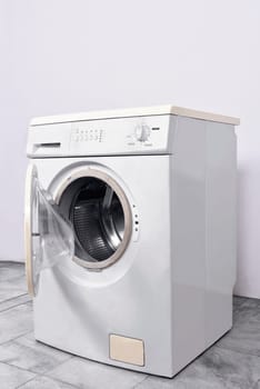 Washing machine with open door at home. Home appliances