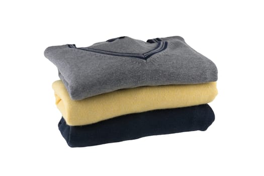 Cashmere sweater. A Stack of grey, yellow and black  cozy warm sweater for men isolated on white. Fashion winter for men.
