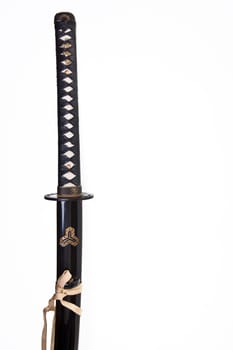 Japanese katana or samurai sword over a white background