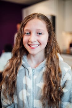 Portrait of a little girl at home wearing pyjamas.