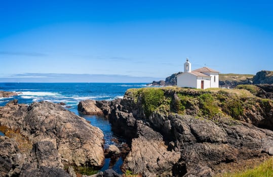 The hermitage of the Virgen del Puerto in Meirás, A Coruna, Galicia, Spain.Landscape of the coast of Galicia, lighthouse.