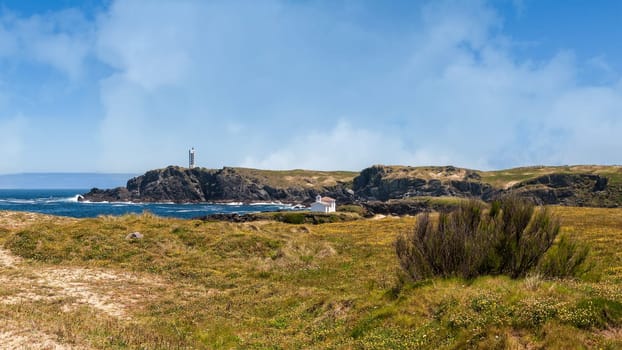 The hermitage of the Virgen del Puerto in Meirás, A Coruna, Galicia, Spain.Landscape of the coast of Galicia, lighthouse.