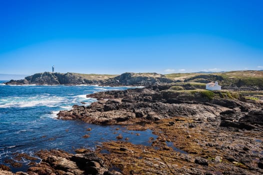 The hermitage of the Virgen del Puerto in Meirás, A Coruna, Galicia, Spain.Landscape of the coast of Galicia, lighthouse.