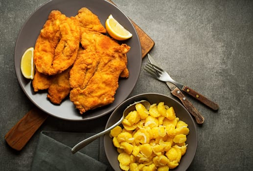 Homemade breaded or fried chicken steak - German Weiner Schnitzel with potato salad