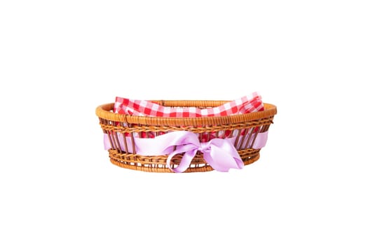 Empty basket with purple ribbon and therein a red checkered napkin isolated on white background. For your food and product display montage.
