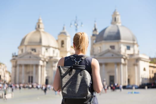 Female tourist with a fashinable vintage hipster backpack on Piazza del Popolo, People's Square, in Rome, Italy.