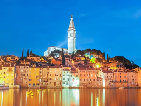 Colorful sunset of Rovinj town, Croatian fishing port on the west coast of the Istrian peninsula. Colorful evening seascape of Adriatic Sea. Traveling concept.