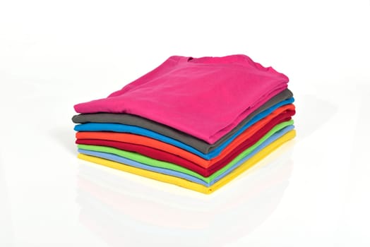 Colorful clothes pile isolated over white background