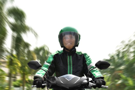 Asian motorcycle taxi rider rushing on the street