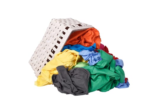 Colorful clothes spilled from wooden basket isolated over white background
