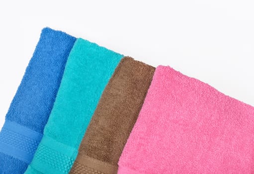 Pile of tidy folded towels isolated over white background