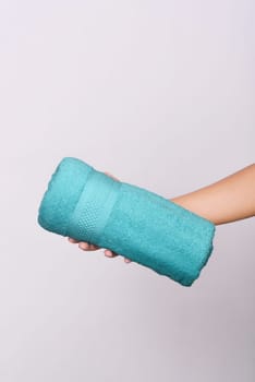 Colored towel on human hands isolated over white background
