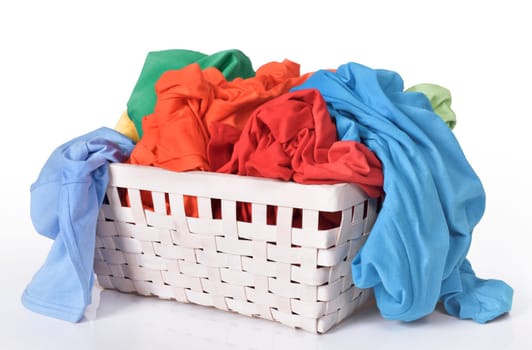 Colorful dirty clothes in laundry basket isolated over white background