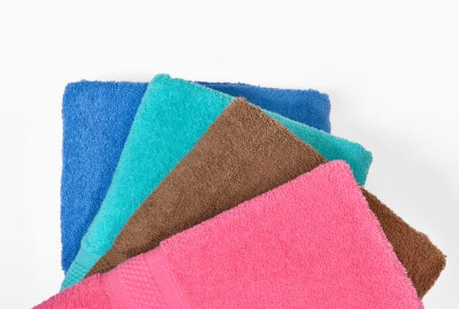 Pile of tidy folded towels isolated over white background