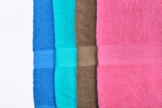 Pile of tidy folded towels isolated over white background