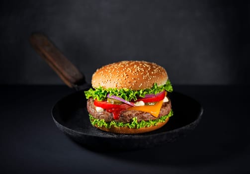 Making Homemade hamburger or burger with fresh vegetables and cheese