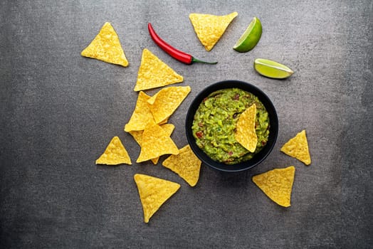 Bowl of delicious homemade traditional Guacamole sauce with nachos