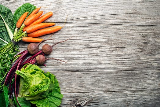 Assortment of fresh vegetables and ingredients on wooden rustic background